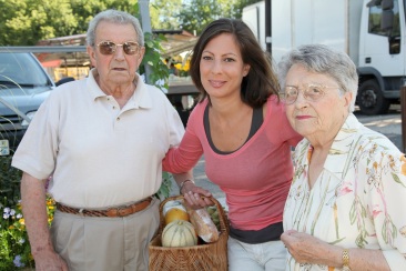 Closeup of young woman with couple of elderly persons